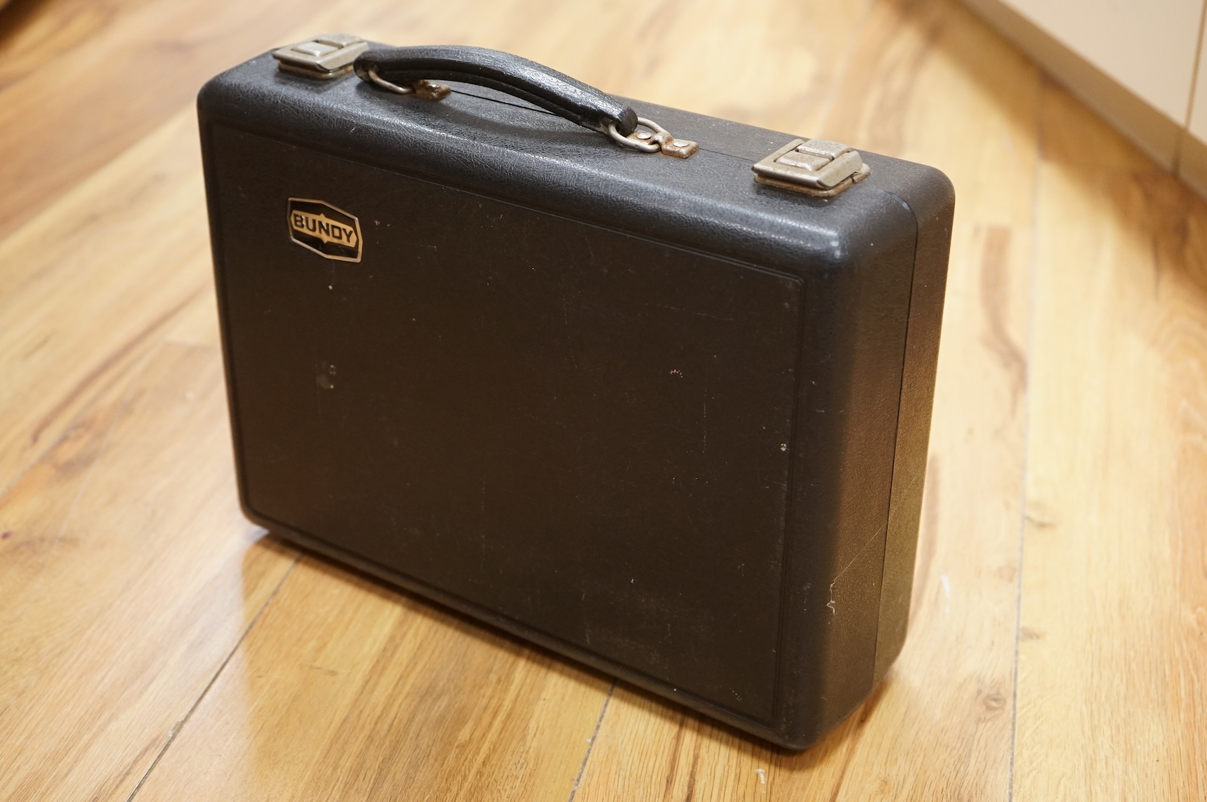 A cased Selmer plastic Bb clarinet.